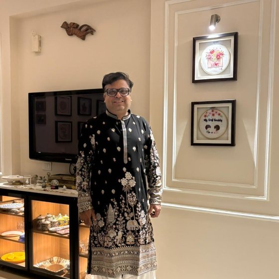 Customer in an ivory printed kurta at a home puja